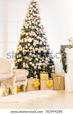 New Year's decor. Christmas tree. Christmas tree with gifts. New Year's toys gold 