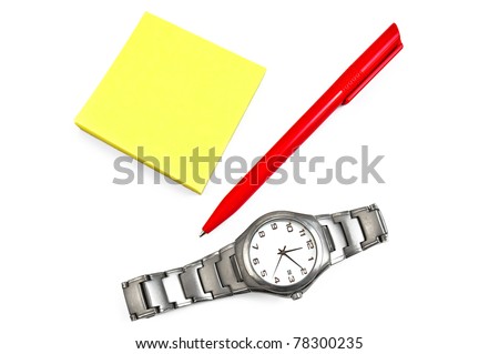 A stack of yellow office paper with a red pen and a silver watch isolated on white background