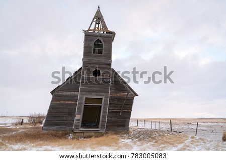 An abandoned church sits decaying and falling apart in the plains of northeast Montana in the ghost town of Dooley. Royalty-Free Stock Photo #783005083