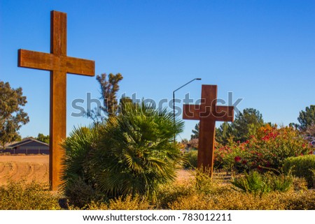 Two Wooden Crosses Against Blue Sky Background