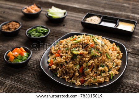 fried rice in plate on table in restaurant Royalty-Free Stock Photo #783015019