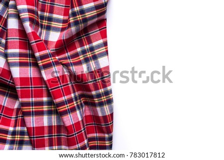 Flat lay of scarf with Christmas tartan texture on white background