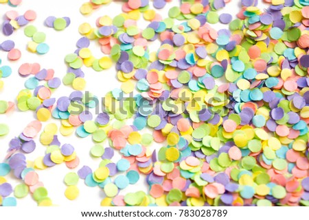 Confetti scattered in different colors on a white background. Festive confetti. The decor for the party.