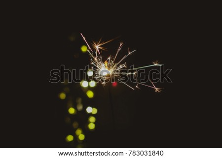 Abstract blur sparklers for celebration christmas,happy new year,party,festival background,Motion Blurred by wind Sparklers with pentagon bokeh background.Winter Dark vintage night  film grain style.