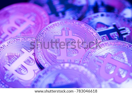 Unique bitcoin group photo. Conceptual closeup image for worldwide cryptocurrency and digital payment system. Violet metallic reflections.