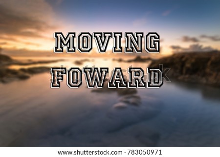 words "MOVING FOWARD" written on blurred sunset seascape background. Happy New year concept.