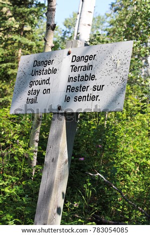 Danger unstable ground, stay on trail sign.