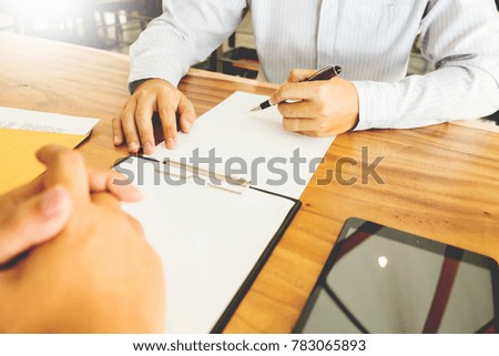 Close-up Of Businessperson Signing Contract,woman writing paper at the desk with pen and reading books at table with basic Form document working in office.