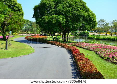 The garden has a colorful flower canal walkway natural landscape with blue sky background