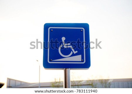 Wheelchair symbol up the slope. Blue signboard for disabled wheelchairs to tell direction and get up in cafe. accessibility ramp sign for wheelchair . Inclined for disable or wheel chair person