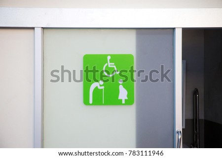 Green label on slice toilet door, priority for distable person in the oilbank station. priority benefits of the special people. image for objects, background, article and copy space.