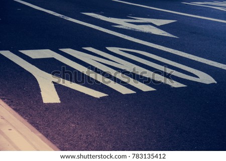 “Only” text sign and arrow on road in vintage style