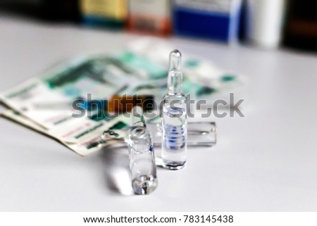 syringe with medication on a background of money
