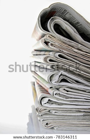 newspaper piled up on a table in a office with white background no people stock photo Royalty-Free Stock Photo #783146311