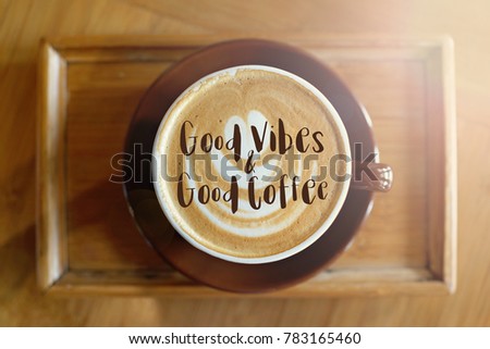 Top view image of coffee cup on wooden desk with text. Good Vibes and Good Coffee. Flat lay. 