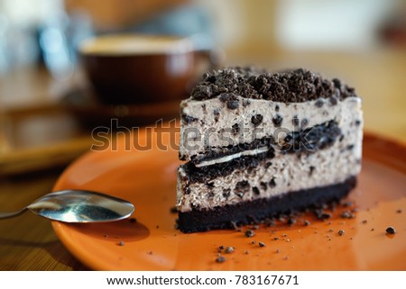 Oreo cheesecake on plate, with coffee latte background