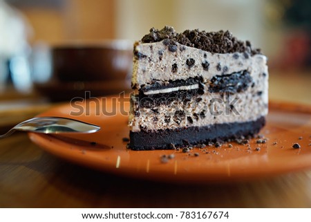 Oreo cheesecake on plate, with coffee latte background
