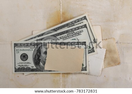 Money and blank and empty photo frames on vintage background and texture