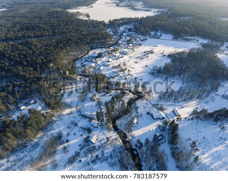 Aerial view over rural Latazeris village in Lithuania, Europe. During snowy cold winter day.