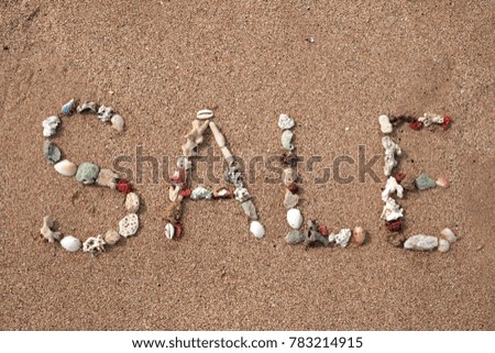 Text Sale made from shell on sandy beach. Background for ad or web design