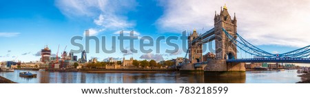 Panoramic London skyline with iconic symbol, the Tower Bridge and Her Majesty's Royal Palace and Fortress, known as the Tower of London as viewed from South Bank of the River Thames in the morning Royalty-Free Stock Photo #783218599