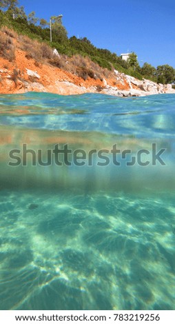 Sea level photo of tropical turquoise clear waters and rocky seascape