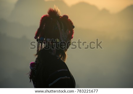 young asian lady Akha tribe,Akha hill standing on the mountain in the morning, Chiang Rai Thailand