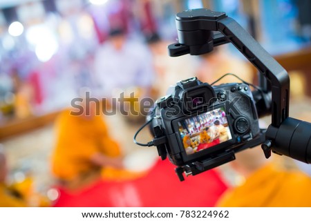 Steadicam with DSLR camera for video production are shooting movie in wedding ceremony. stabilize tool. stabilizer control machine. movie technology. image for background, objects and copy space. Royalty-Free Stock Photo #783224962