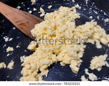 scrambled egg in a black pan