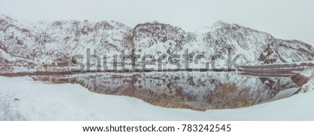 Mirror lake in a snowfall, Pyrenees (La Vall Fosca)