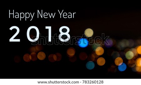 A Happy New Year  2018 text over blur image of lights.