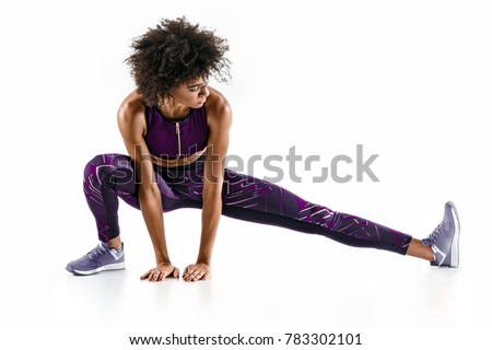 Beautiful young girl stretching her hamstrings. Photo of sporty girl doing exercising on white background. Sports Royalty-Free Stock Photo #783302101