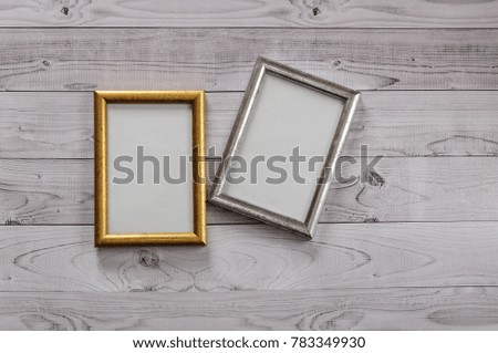 Two frames for photos on a light, vintage wooden background