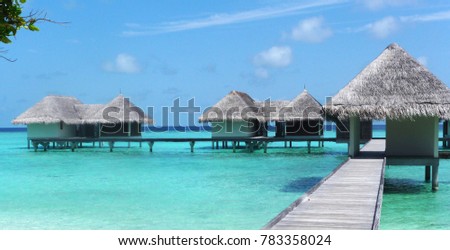 Water villas suspended over the turquoise waters of The Maldives.