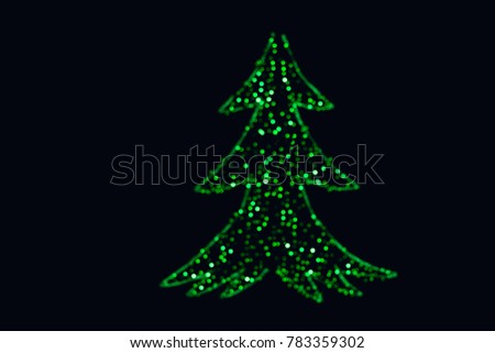 Defocused christrmas tree with a black background.