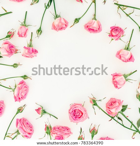 Floral frame with pink roses, branches and leaves on white background. Flat lay, Top view. Woman day composition