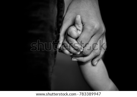 father's hand lead his child son in dark background, trust family concept.
selective focus Royalty-Free Stock Photo #783389947