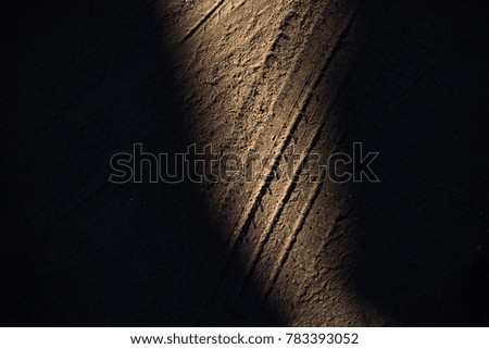 Tyre track on dirt sand or mud, retro tone, grunge tone, drive on sand, off road track, shadow, dark, light,