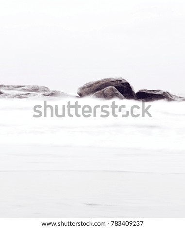 Some big stones in a long exposure in the sea. Decorative photo of the sea.