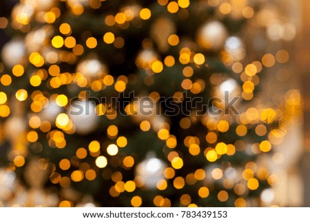 Yellow lights of a tree garland. Abstract blurred Christmas background, bokeh. Glowing light bulbs.