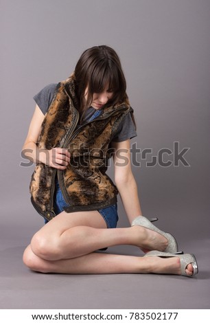 Cute Millennial Woman in Furry Vest and Overalls and Heels