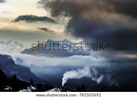 Beautiful alpine peaks view from the top over the clouds, natural landscape , Switzerland