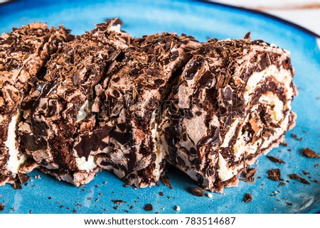 Belgian Chocolate Meringue Roulade filled with whipped cream and chocolate sauce