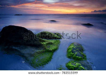 Sunset view with rocks covered with green moss at Kudat Sabah Malaysia. A famous place and most visited for photographers to take pictures.