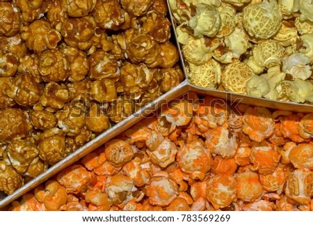 Top view of a variety mix of flavored popcorn, separated by dividers.