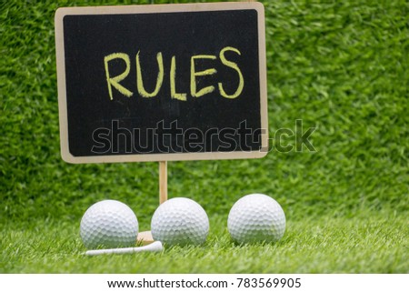Rules of golf sign with golf ball on green grass