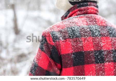 Winter background with man in red buffalo check jacket with copy space