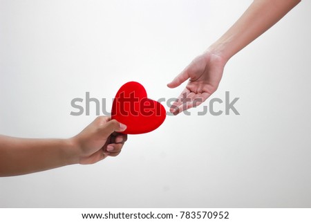 Men hold hearts for women And women are reaching out On a white background, About Valentine day. (selective focus,soft focus) Royalty-Free Stock Photo #783570952