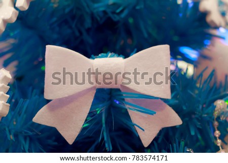 Decorated Christmas tree on blurred, sparkling and fairy background.In the blue tone shop
