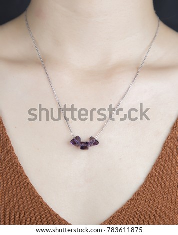The girl wearing the beautiful necklace